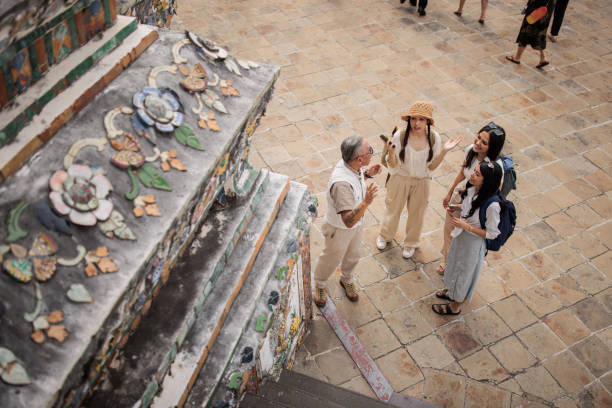 Private tourist guide explaining the city history to women tourists.