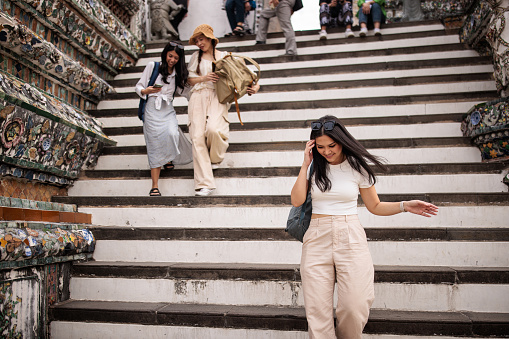 Group of women tourists visiting Wat Arun, Bangkok.