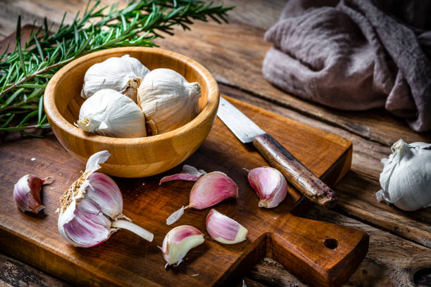 istock Garlic bulb and cloves on wooden table 2065528049