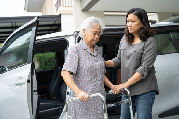 Asian senior woman patient sitting on walker prepare get to her car, healthy strong medical concept. Asian senior woman patient sitting on walker prepare get to her car, healthy strong medical concept. senior adult car nurse physical impairment stock pictures, royalty-free photos & images