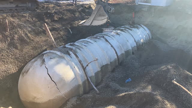 Industrial Excavator Moves Large Fiberglass Tank
