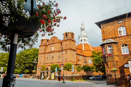 Panorama of Nikiszowiec brick architecture with flowers in the foreground in focus, Katowice, Poland
