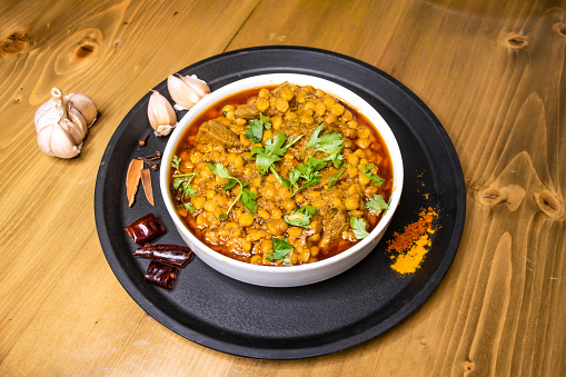 dal chana and mezbani gosht served in dish isolated on wooden background top view indian spices, bangladeshi and pakistani food