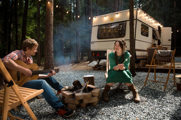 istock happy couple living in caravan in forest 2065583899