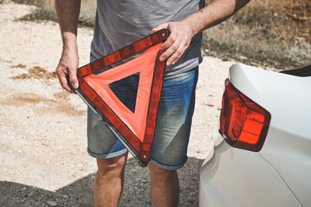 man stands by a broken car - stranded travel people traveling disappointment - fotografias e filmes do acervo