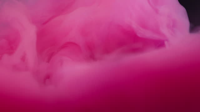 Close up slow motion of Pink acrylic color ink in water, like an explosion or clouds