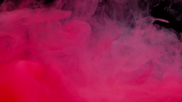 Close up slow motion of Red color ink in water, like an explosion or clouds