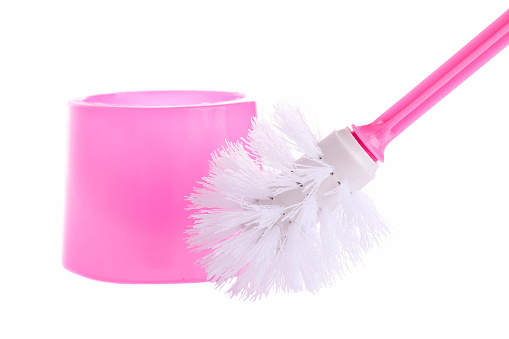 Pink toilet brush with long handle isolated on white background.