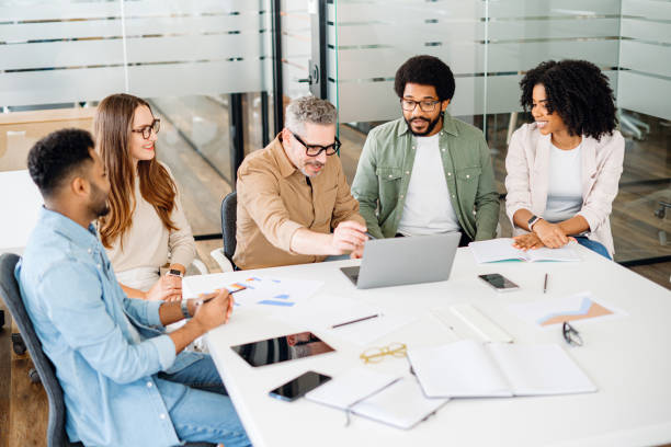 istock Colleagues engage in a lively exchange of ideas in an office 2065627423