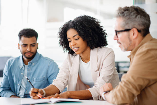 istock Colleagues engage in a lively exchange of ideas in an office 2065627431