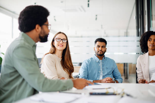 istock A diverse team listens attentively, with a male employee making a point 2065627432