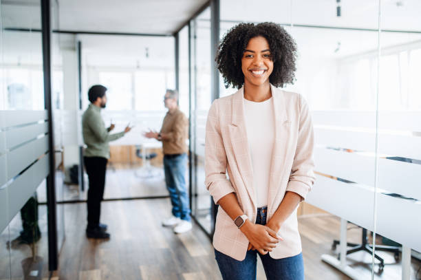 istock A young professional woman stands confidently in a modern office 2065627449