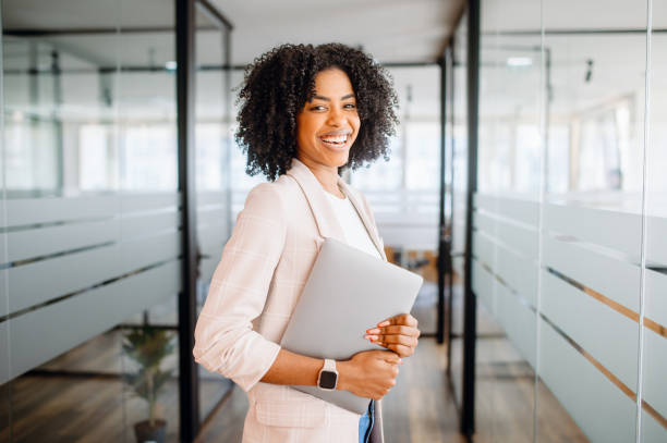 istock A young professional woman stands confidently in a modern office 2065627453