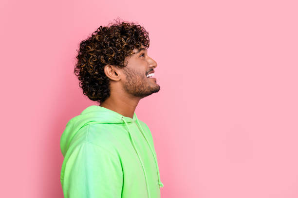 istock Side profile photo of cheerful interested young guy looking up billboard with information opening store isolated on pink color background 2065629144
