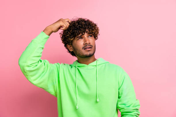istock Portrait of thoughtful indian student wavy hair man scratch head looking empty space lectures schedule isolated on pink color background 2065632963