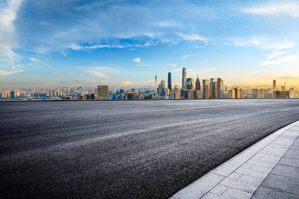istock Empty asphalt road and city skyline background at sunset 2065635125