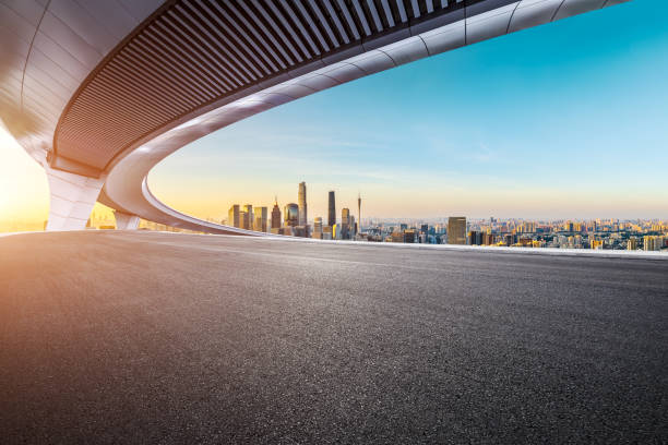 istock Empty asphalt road and city skyline background at sunset 2065636862