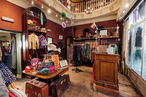 A vintage clothing store in Durham, North East England with a wide variety of merchandise on display for sale and there is no people in the shop.