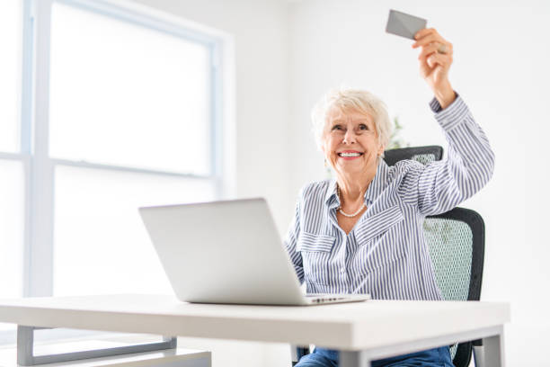 istock senior women using a laptop while sitting at the office 2065673271