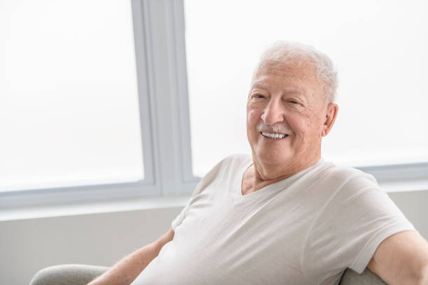 istock senior men sitting on couch at home 2065677925