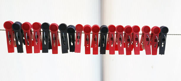 istock red and black clothespins on a white background 2065678529