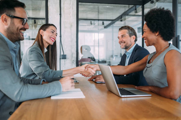 istock Businesswomen shaking hands across the table. 2065681285