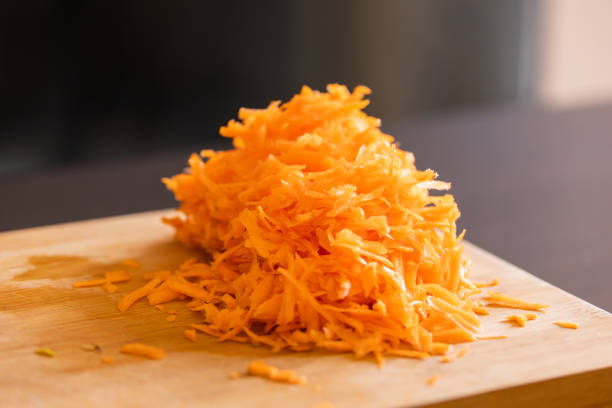 istock grated fresh carrots on wooden board close-up 2065695453