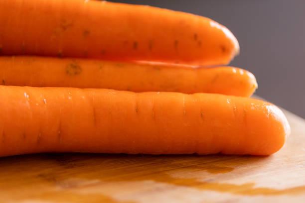 fresh carrots on wooden board close-up