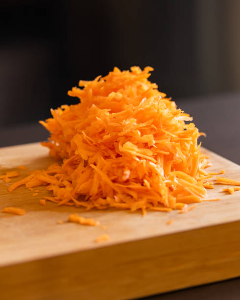 istock grated fresh carrots on wooden board close-up 2065695461