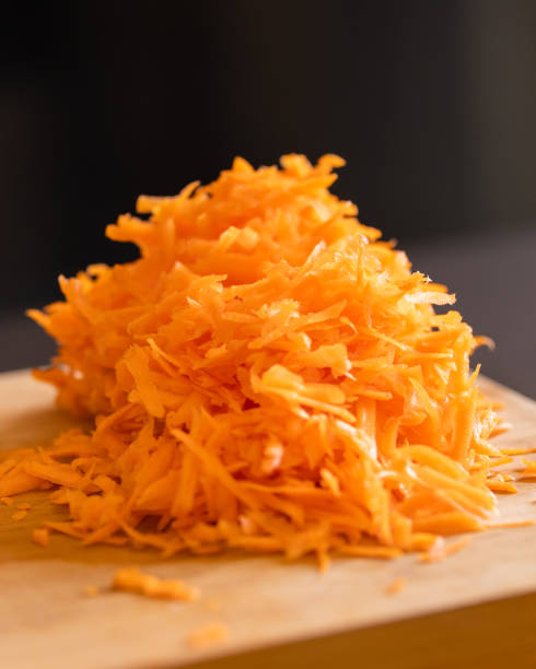 istock grated fresh carrots on wooden board close-up 2065695467