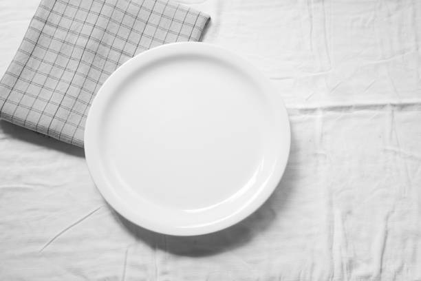 Empty white dish on napkin with space for your design.