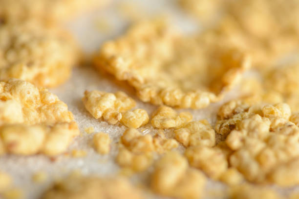 Extreme macro of corn flakes crumbs on sugar crystals