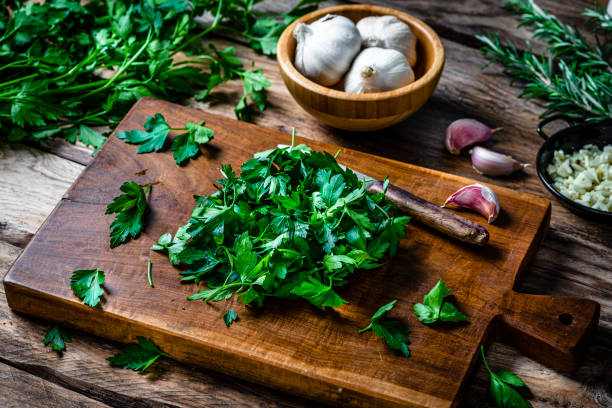 Freshly chopped parsley on wooden cutting board