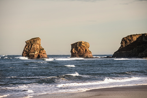 Natural rock formations along beach coastline in north of Spain. Stunning view.