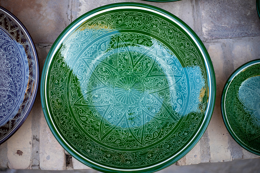a green handmade plate in a display of a shop, Khiva, the Khoresm agricultural oasis, Citadel.