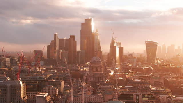Golden hour aerial slider shot of St Pauls cathedral and the city of London skyscrapers