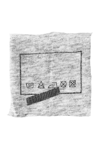 Care instructions information printed on knit fabric patch isolated over white