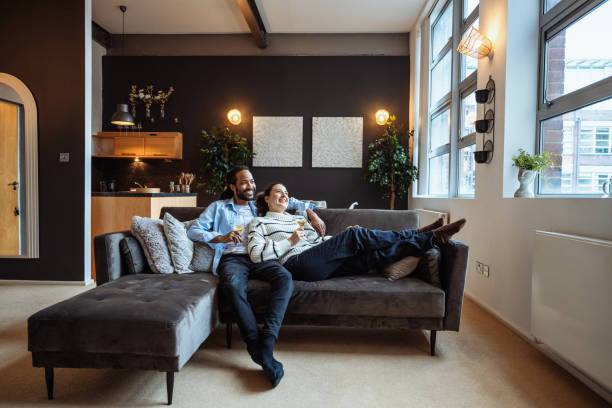 istock Heterosexual multiethnic couple at home enjoying evening and drinking white wine 2065737592