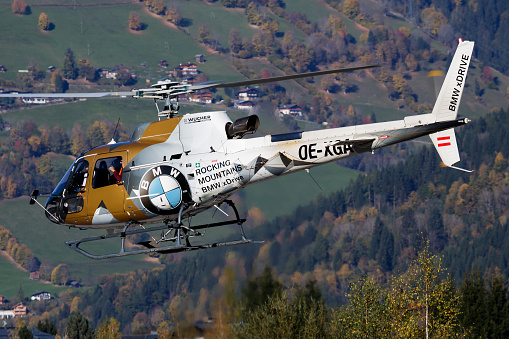 Zell am See, Austria - October 14, 2017: Commercial helicopter at airport and airfield. Rotorcraft. General aviation industry. Civil utility transportation. Air transport. Fly and flying.