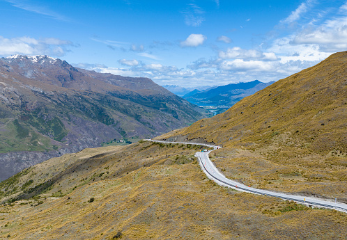 Experience the awe-inspiring Crown Range Summit Overlook on your journey to Queenstown, New Zealand, offering breathtaking vistas and memorable moments.