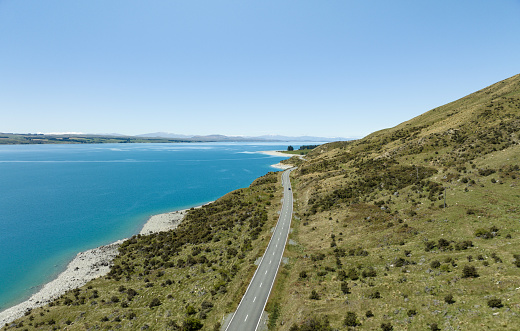Discover tranquility on an idyllic road alongside Lake Pukaki in New Zealand, where breathtaking scenery and peaceful moments await.