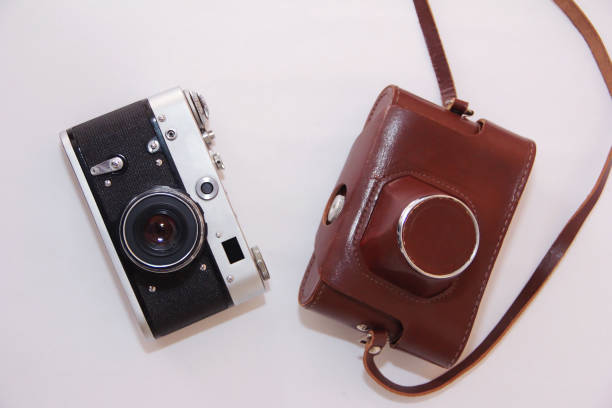 An old rare photo camera and its storage box on a white background