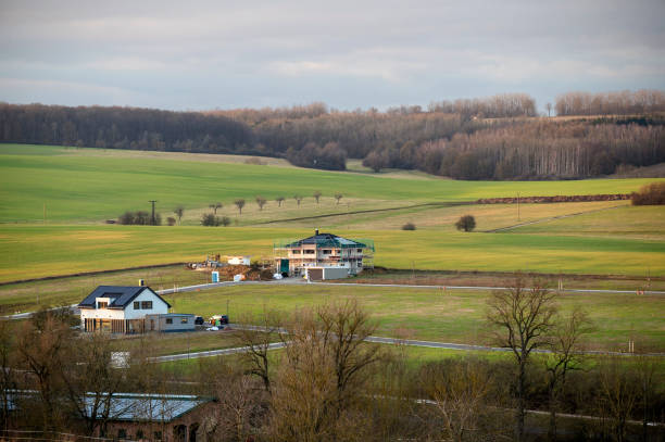 Thuringia, Germany - 17 February 2024: Individual houses stand on a field that is to become a new housing estate.