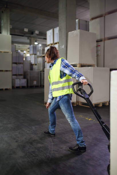 istock Female worker transporting boxes in warehouse 2065755623