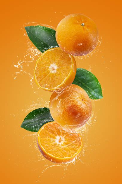 istock Water splashing on Fresh Sliced oranges and Orange fruit on a Orange background 2065790481