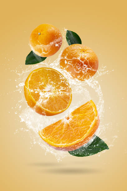istock Water splashing on Fresh Sliced oranges and Orange fruit on a Orange background 2065790977