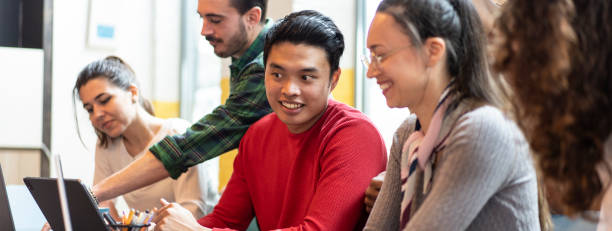 istock Horizontal banner or header with young co-workers multiethnic team planning a new startup - People working on a new project in creative coworking office - Bright filter with focus on asian man face 2065796693