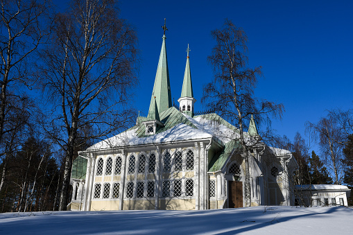 Jokkmokks kyrka in spring winter. Sun is shining and snow is on the ground. Jokkmokk. Norrbotten. Lapland. Laponia. Church.