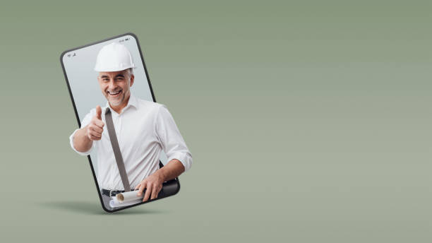 istock Cheerful construction engineer giving a thumbs up in a smartphone videocall and smiling, online  service concept 2065805228