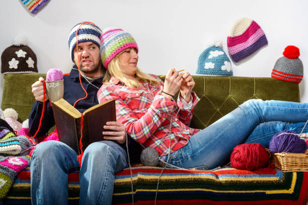 Woman knitting and man reading a book